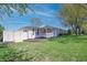 Inviting home with a well-kept lawn, charming white fence, and a vibrant green leafy tree at 2305 Caldwell Pl, Columbus, IN 47201