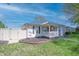 Quaint home featuring a fenced yard, complemented by lush green grass and manicured garden beds at 2305 Caldwell Pl, Columbus, IN 47201