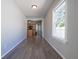 Hallway featuring hardwood floors and neutral paint, leading to the kitchen at 2305 Caldwell Pl, Columbus, IN 47201
