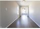 Hallway with hardwood floors leading into a sunroom with lots of light at 2305 Caldwell Pl, Columbus, IN 47201