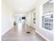 Bright hallway showcasing pristine floors, sunlit windows, and a glimpse into the living area at 2305 Caldwell Pl, Columbus, IN 47201