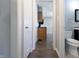 Hallway view leading to bathroom and kitchen with wood laminate flooring at 2305 Caldwell Pl, Columbus, IN 47201