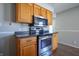 Kitchen showcasing stainless steel oven, cooktop and wood cabinetry at 2305 Caldwell Pl, Columbus, IN 47201