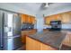 Kitchen boasts stainless steel appliances, central island, and wood cabinetry at 2305 Caldwell Pl, Columbus, IN 47201