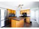 Well-lit kitchen features an island, stainless steel appliances, and plenty of cabinet space at 2305 Caldwell Pl, Columbus, IN 47201