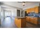 Bright kitchen showcasing an island, stainless steel refrigerator, and a view into the sunroom at 2305 Caldwell Pl, Columbus, IN 47201