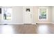 Bright living room with light gray wood-look floors, white walls, and bright natural lighting at 2305 Caldwell Pl, Columbus, IN 47201