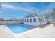Backyard features a clean pool and an enclosed sunroom with many windows at 2305 Caldwell Pl, Columbus, IN 47201