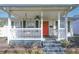 Welcoming porch with swing, adorned with a vibrant front door and stylish house numbers at 2305 Caldwell Pl, Columbus, IN 47201