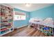 Cheerful bedroom with bright blue walls and a lofted bed with storage underneath at 231 N East St, Pendleton, IN 46064