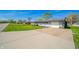 Well-kept single-story home with a long driveway and green lawn at 231 N East St, Pendleton, IN 46064