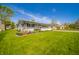 Landscaped front yard of a single-story house with lush green lawn and garden beds at 231 N East St, Pendleton, IN 46064