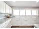 Well-lit kitchen showcasing white cabinets, grey countertops, and a large window at 231 N East St, Pendleton, IN 46064