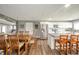 Open kitchen and dining area with island, stainless steel fridge and table with chairs at 231 N East St, Pendleton, IN 46064
