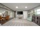 Open-concept living space with a TV, dining area, and a charming accent wall at 231 N East St, Pendleton, IN 46064