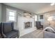 Bright living room featuring a brick fireplace, neutral walls, and comfortable seating at 231 N East St, Pendleton, IN 46064