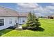 Open backyard with lush green grass and small patio area, perfect for relaxing outdoors in the shade at 2342 Sheek Rd, Greenwood, IN 46143