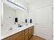 Bathroom featuring a double sink vanity, large mirror, and updated fixtures at 2342 Sheek Rd, Greenwood, IN 46143