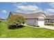 Charming single story home showcasing well-kept lawn, lovely landscaping, and a two-car garage with a wide driveway at 2342 Sheek Rd, Greenwood, IN 46143