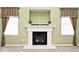 Living area featuring fireplace with mantle, and decorative window treatments at 2342 Sheek Rd, Greenwood, IN 46143