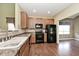 Kitchen featuring wood cabinets, granite countertops, and modern appliances at 2342 Sheek Rd, Greenwood, IN 46143