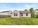 Nice backyard showing the home's exterior and a lush lawn with neighboring houses visible at 2523 Gammon Dr, Indianapolis, IN 46234