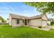 Inviting home with a brick facade, charming porch, well-manicured lawn, and classic shutters at 2523 Gammon Dr, Indianapolis, IN 46234