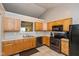 Well-lit kitchen with black appliances, light oak cabinetry, and a neutral countertop at 2523 Gammon Dr, Indianapolis, IN 46234