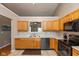 Bright kitchen featuring sleek black appliances, light oak cabinetry, and a view to the breakfast nook at 2523 Gammon Dr, Indianapolis, IN 46234