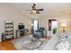 Bright living room featuring a ceiling fan, modern furnishings, and an open doorway at 2523 Gammon Dr, Indianapolis, IN 46234