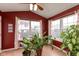 Cozy sunroom bathed in natural light with plants and views of the backyard at 2523 Gammon Dr, Indianapolis, IN 46234