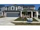 Charming two-story home featuring a two-car garage, brick accents, and well-manicured lawn with Pulte Homes signage at 2717 Penn Ave, Plainfield, IN 46168