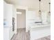 Bright, modern kitchen features white cabinets, island with sink, and stainless steel appliances at 2717 Penn Ave, Plainfield, IN 46168