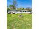 Large backyard featuring a long white home and a grassy lawn at 2871 N Talley Rd, Columbus, IN 47203