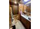 Bathroom with wooden paneling, a toilet, shower with a shower curtain, sink and tiled floors at 2871 N Talley Rd, Columbus, IN 47203