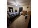 Bedroom with carpet, ceiling fan, window with dark curtains, and bed with blue striped comforter at 2871 N Talley Rd, Columbus, IN 47203