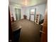 Bedroom featuring a window with curtains, carpets, and a dark storage unit at 2871 N Talley Rd, Columbus, IN 47203