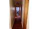 Hallway featuring hardwood floors and multiple doors leading to various rooms in the home at 2871 N Talley Rd, Columbus, IN 47203