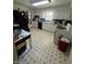 Spacious kitchen with white cabinets, black appliances, and blue and white tile accents at 2871 N Talley Rd, Columbus, IN 47203