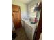 Laundry room featuring a washer and dryer, small window, and linoleum floors at 2871 N Talley Rd, Columbus, IN 47203