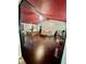 Bright living room with hardwood floors, red accent wall, and beamed ceiling at 2871 N Talley Rd, Columbus, IN 47203