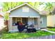 Charming single-story home with a front porch, grill, and landscaping at 321 Harlan St, Indianapolis, IN 46201