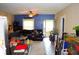 Open-concept living room with ceiling fan, dining area, and tile floors at 321 Harlan St, Indianapolis, IN 46201