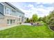 Expansive backyard with lush green lawn, mature trees, and outdoor living spaces at 3387 Keystone Pass, Plainfield, IN 46168