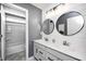 Modern bathroom with a double vanity, sleek fixtures, shiplap walls, and neutral color palette at 3387 Keystone Pass, Plainfield, IN 46168