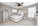 Cozy bedroom features neutral tones, ceiling fan, and a bright window with great natural light at 3387 Keystone Pass, Plainfield, IN 46168