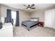A simple bedroom with a desk area, ceiling fan, and bright window with dark blue accents at 3387 Keystone Pass, Plainfield, IN 46168