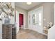 Bright entryway featuring hardwood floors, glass paneled front door, and stylish decor at 3387 Keystone Pass, Plainfield, IN 46168