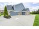 Exterior shot of a home with a wide driveway and a three-car attached garage at 3387 Keystone Pass, Plainfield, IN 46168