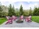 Outdoor stone fire pit with Adirondack chairs surrounded by decorative landscaping at 3387 Keystone Pass, Plainfield, IN 46168